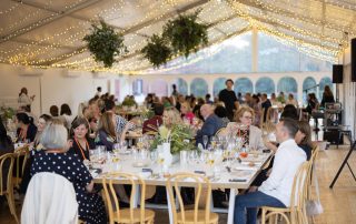 Guests at a corporate event in the rose garden