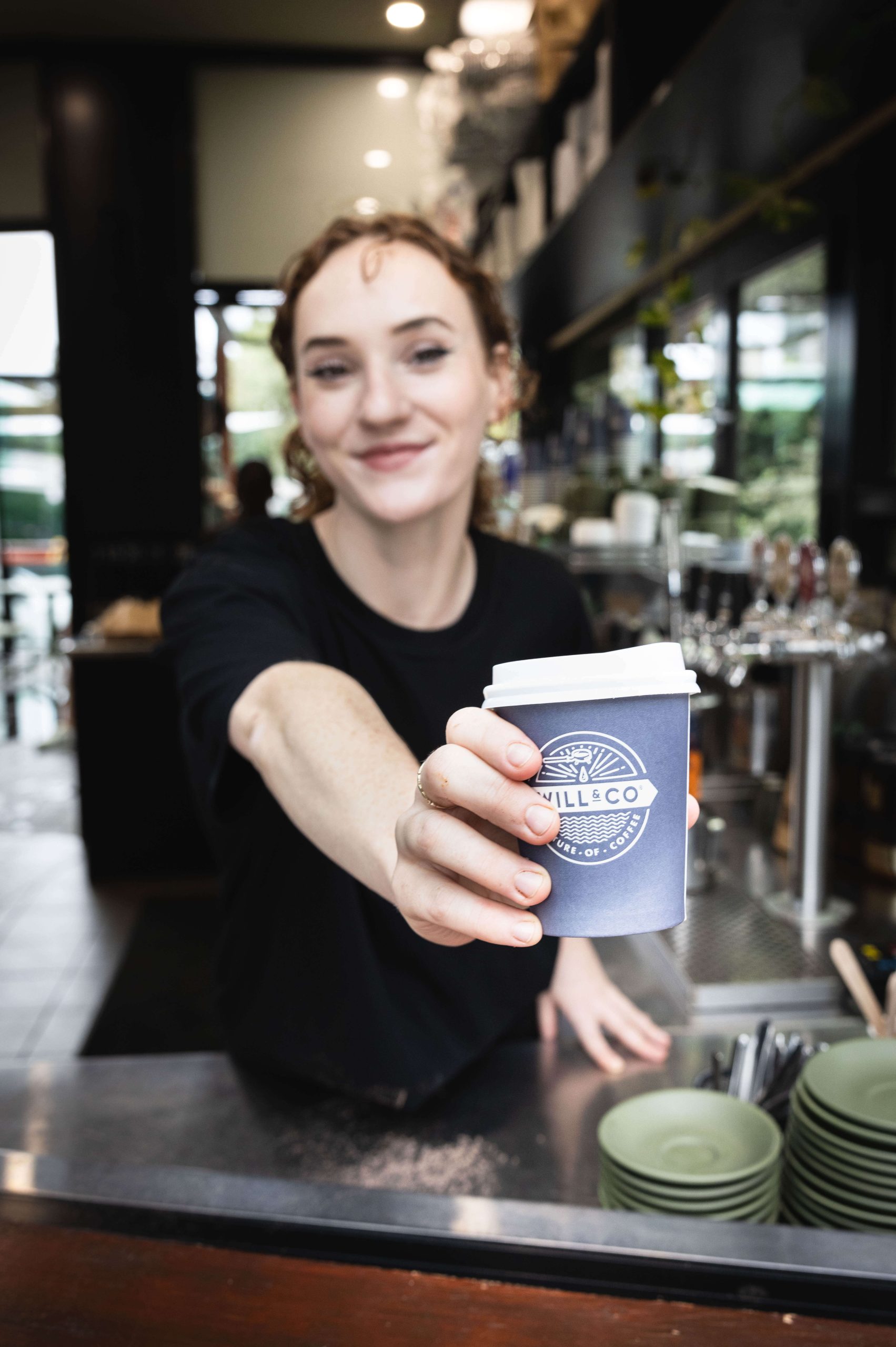 Emma holding a vittoria coffee cup